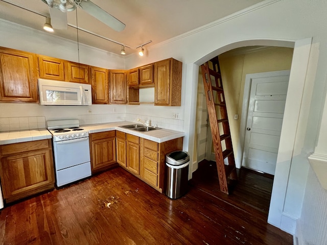 1122 Margaret St, Key West, FL 33040 - kitchen featuring arched walkways, a sink, dark wood-style flooring, white appliances, and crown molding
