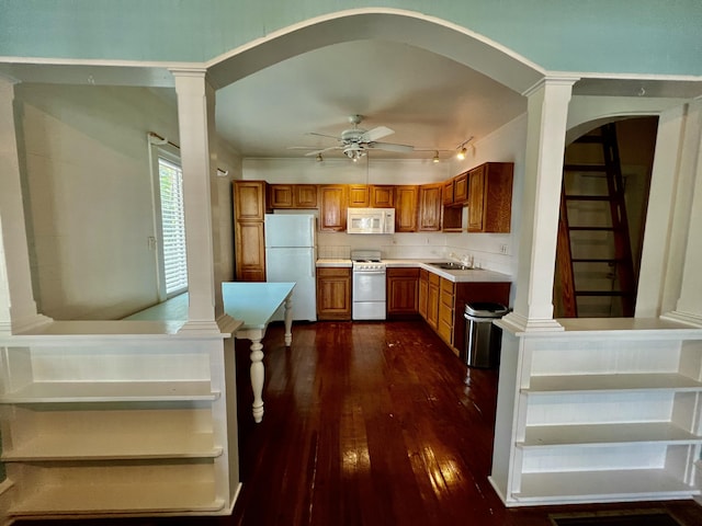 1122 Margaret St, Key West, FL 33040 - kitchen with arched walkways, a sink, white appliances, brown cabinets, and dark wood-type flooring