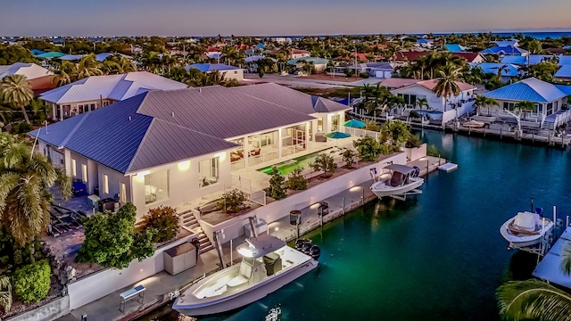 aerial view at dusk with a water view