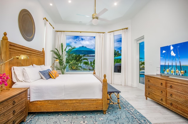 bedroom with ceiling fan, access to outside, and light wood-type flooring