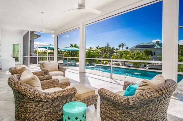 sunroom with a patio, outdoor lounge area, pool water feature, and ceiling fan