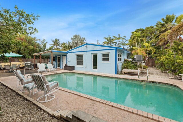 view of pool featuring central AC and a patio area