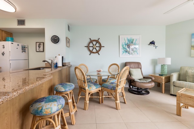 dining room with sink and light tile patterned floors