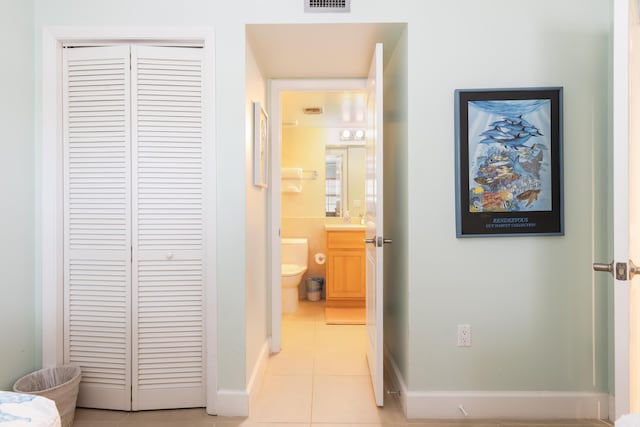 hallway featuring light tile patterned flooring