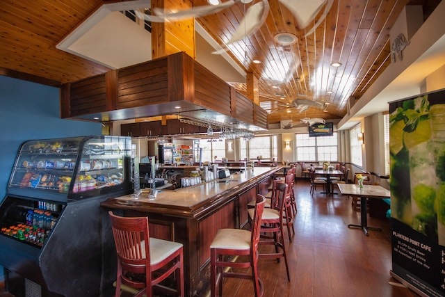 bar with lofted ceiling, wood ceiling, and dark hardwood / wood-style floors