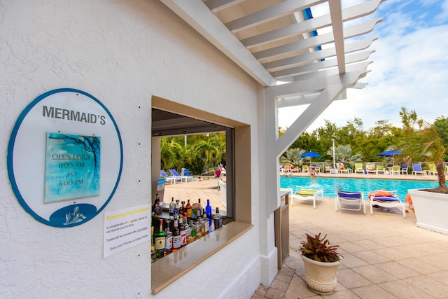 view of swimming pool with a pergola and a patio