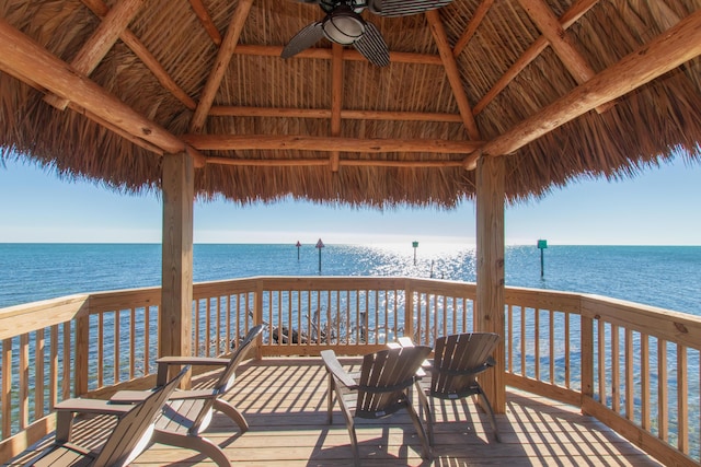 wooden deck featuring a gazebo, a water view, and ceiling fan