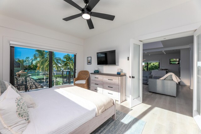 bedroom with ceiling fan, access to outside, and light wood finished floors