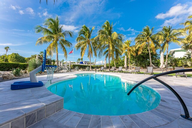 outdoor pool with a patio area