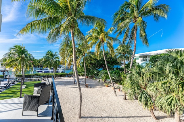 surrounding community featuring a water view and a patio