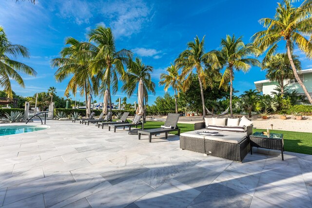 view of home's community featuring a pool, a patio area, and outdoor lounge area