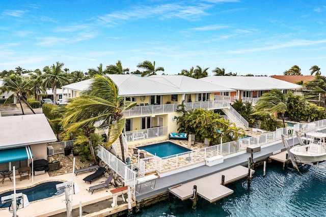 back of house with a patio area and a water view