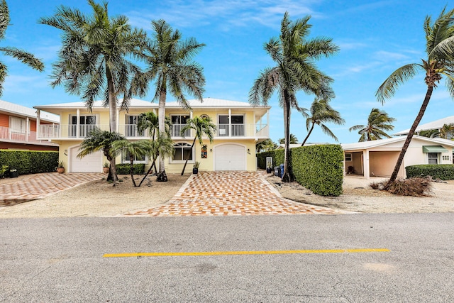 view of front of property featuring a garage and a balcony