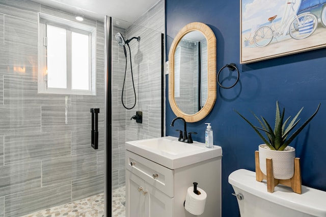 bathroom featuring a stall shower, vanity, and toilet