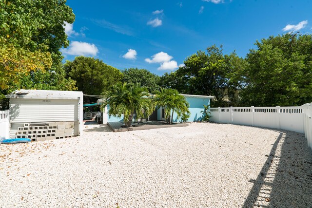 exterior space featuring a fenced backyard and an outdoor structure