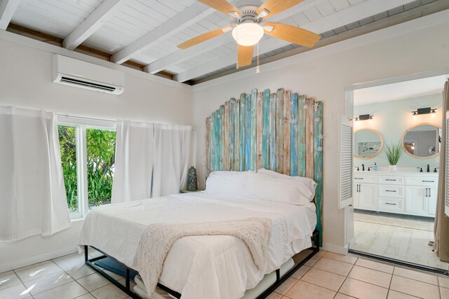 bedroom featuring light tile patterned floors, a wall mounted AC, beam ceiling, and baseboards