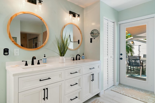 bathroom with a sink and double vanity