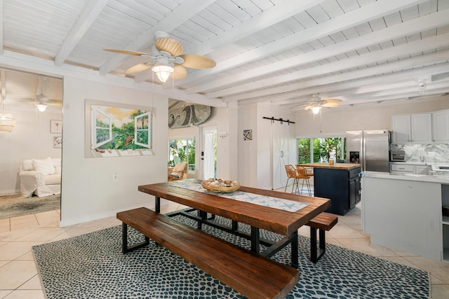 dining room featuring light tile patterned floors, a barn door, wood ceiling, ceiling fan, and beamed ceiling