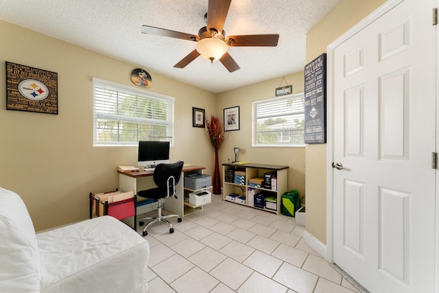 office area with light tile patterned flooring, ceiling fan, and a textured ceiling