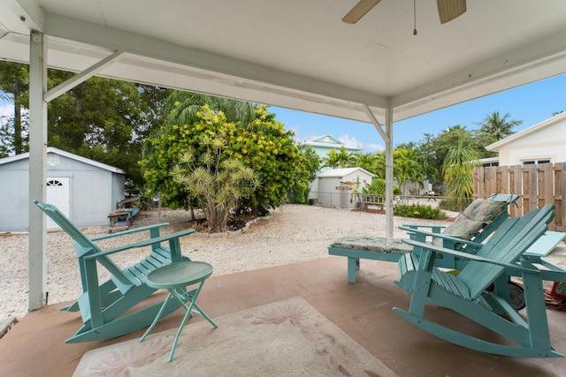 view of patio with ceiling fan and a storage shed