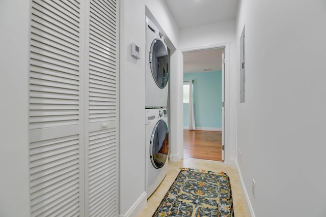 laundry area featuring stacked washer and dryer