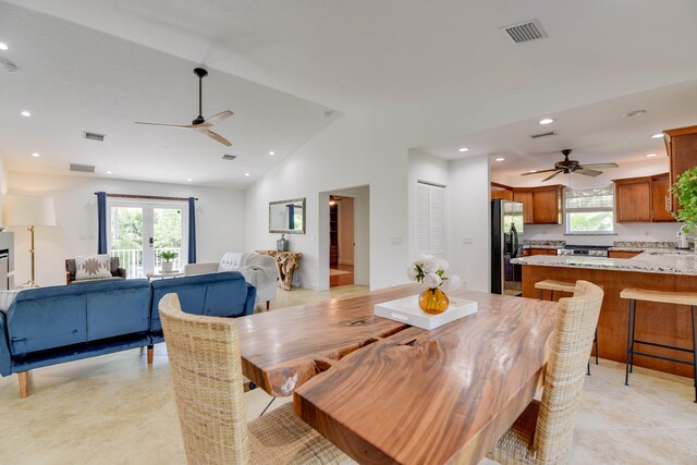 dining room with lofted ceiling, sink, plenty of natural light, and ceiling fan