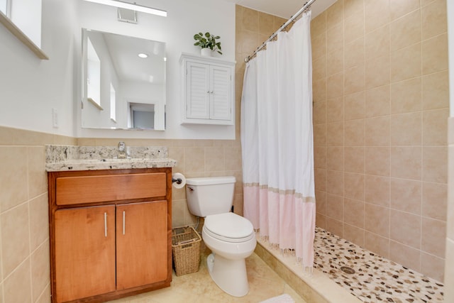 bathroom featuring a shower with curtain, tile patterned floors, vanity, and tile walls