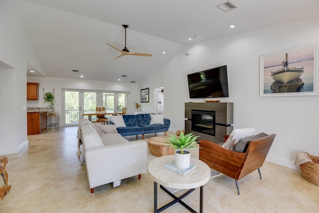 living room featuring ceiling fan, light tile patterned floors, and high vaulted ceiling