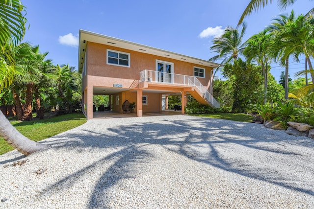 view of front of home with a carport and french doors