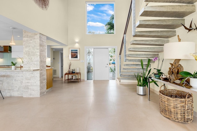 tiled foyer featuring a high ceiling