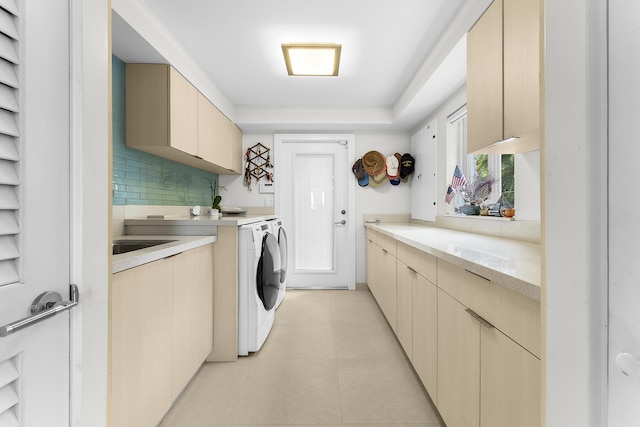 laundry area with cabinets, light tile patterned floors, and washer and dryer