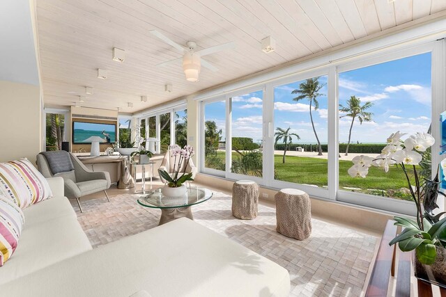 sunroom / solarium featuring wood ceiling and ceiling fan