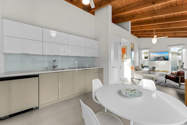 tiled dining area featuring high vaulted ceiling, sink, ceiling fan, wood ceiling, and beam ceiling