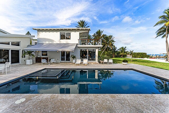 back of house with a balcony and a patio area