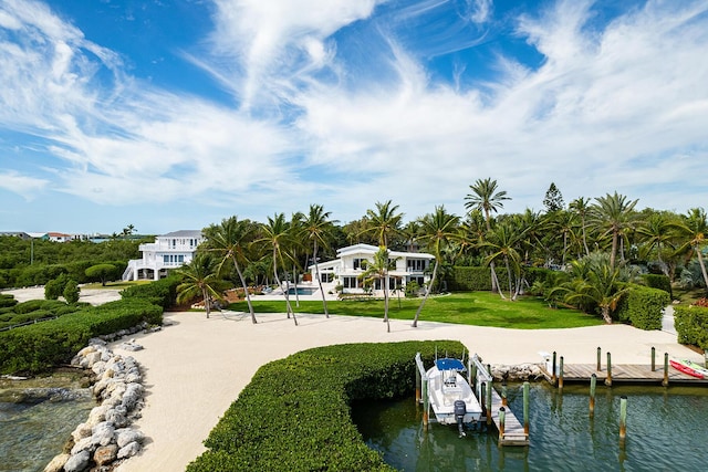 view of dock featuring a water view and a yard