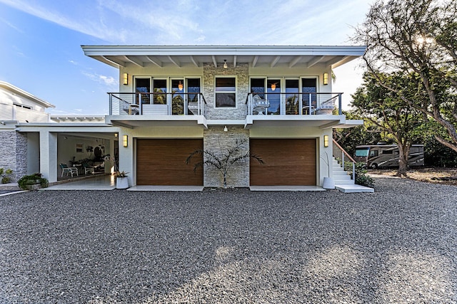 view of front facade with a balcony and a garage