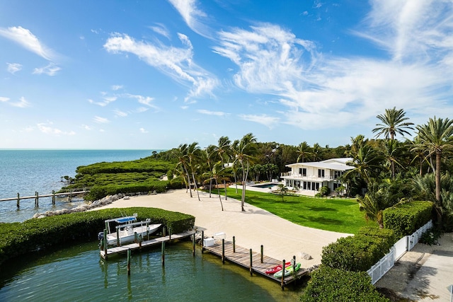 view of dock with a water view and a yard