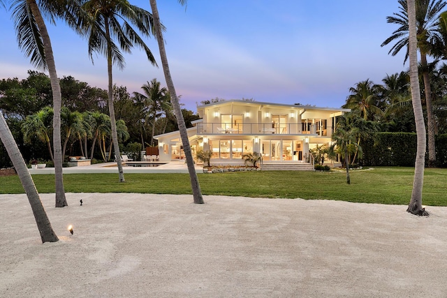 exterior space with a swimming pool, a patio area, and a lawn