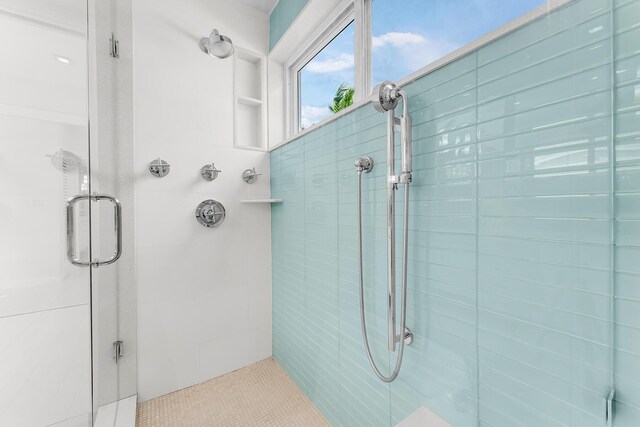 bathroom with a shower with door