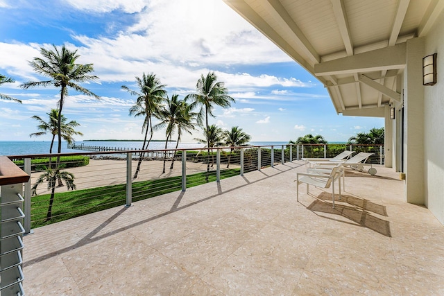 view of patio / terrace featuring a balcony and a water view