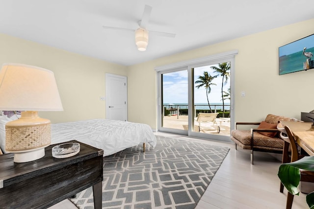 bedroom featuring access to exterior, hardwood / wood-style flooring, and ceiling fan