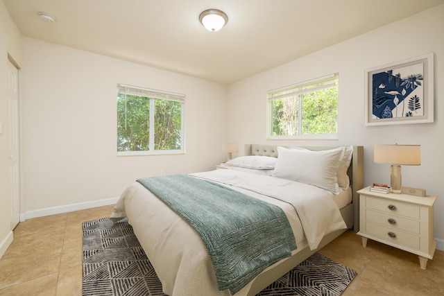 bedroom featuring multiple windows and light tile patterned floors