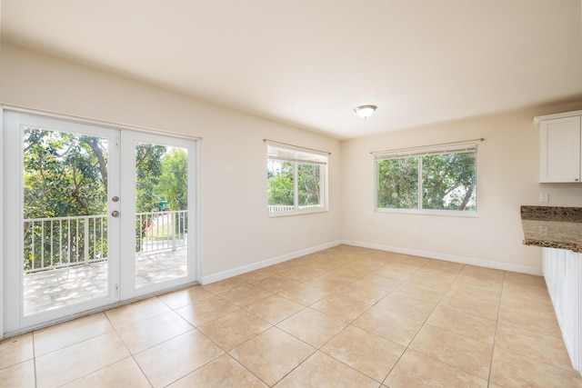 interior space featuring light tile patterned floors and french doors