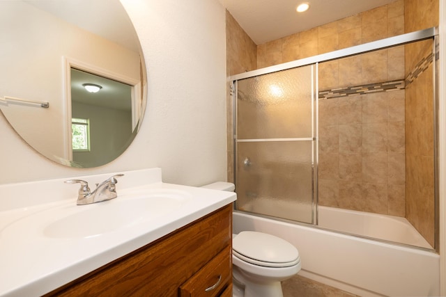 full bathroom featuring enclosed tub / shower combo, vanity, and toilet