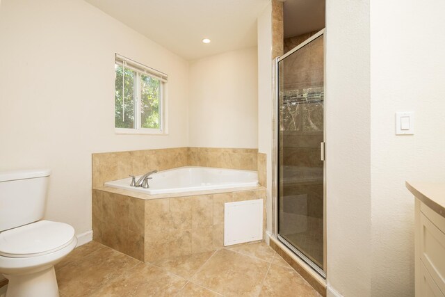 full bathroom with vanity, toilet, tile patterned flooring, and plus walk in shower