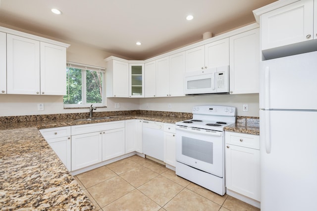 kitchen with white cabinetry, sink, and white appliances