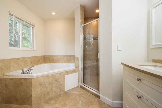 bathroom featuring tile patterned flooring, vanity, and plus walk in shower