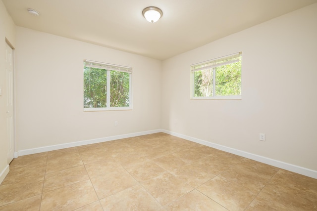 spare room featuring light tile patterned floors