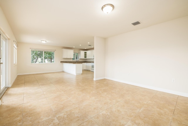 unfurnished living room with light tile patterned floors