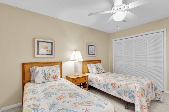 bedroom with carpet flooring, ceiling fan, and a closet